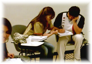 Teen students working with technology in English class