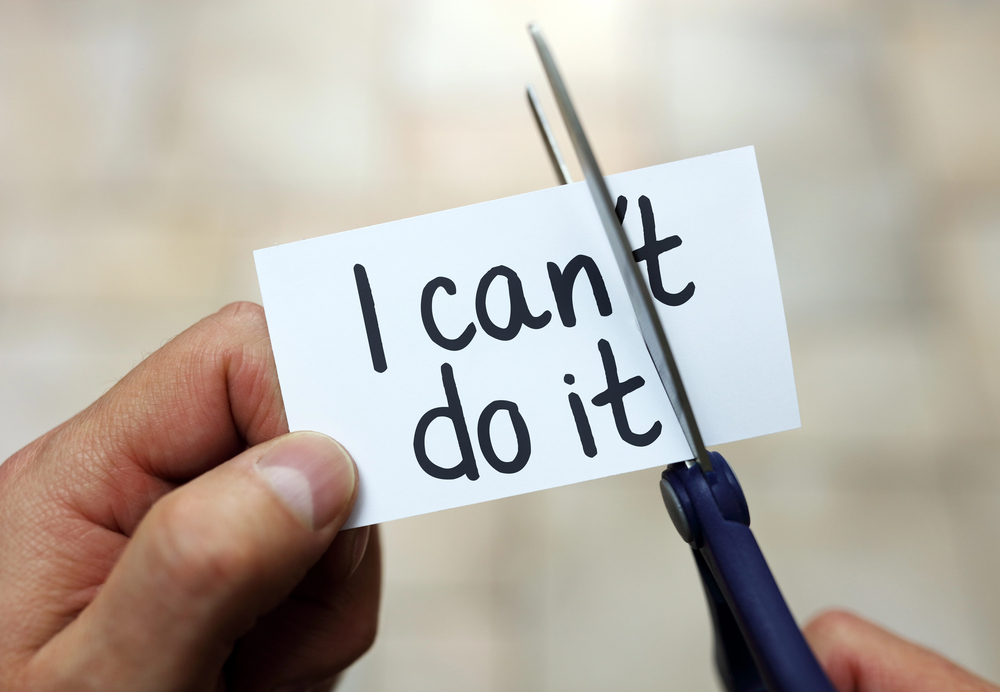 Person using scissors to turn "I can't do it" into "I dan do it."