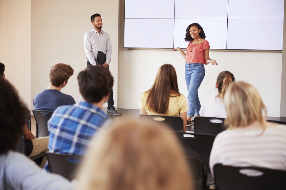 Student giving a presentation at the front of a class